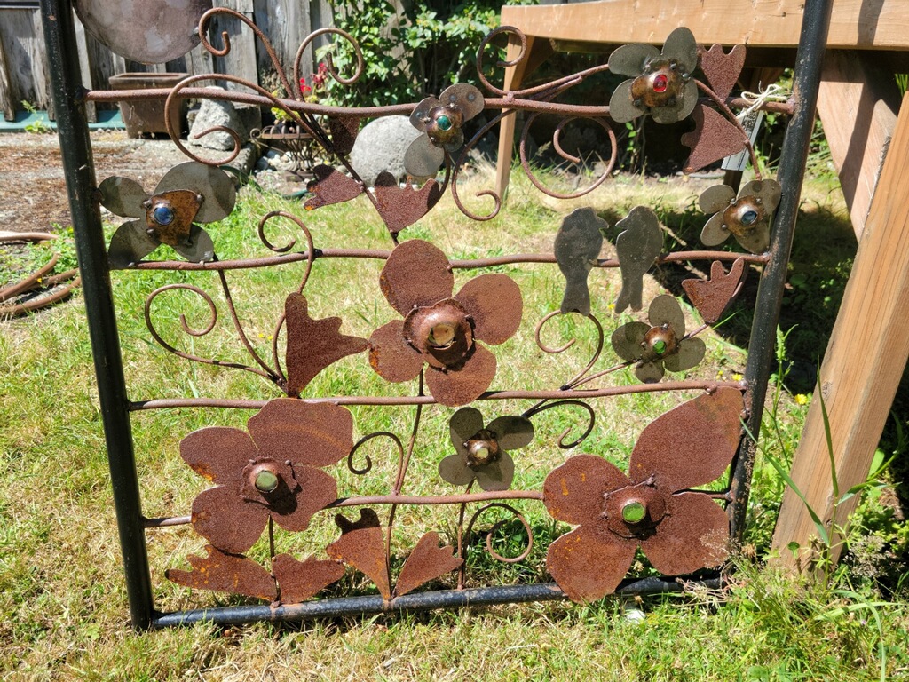 Artful metal garden gate with birds and flower motif